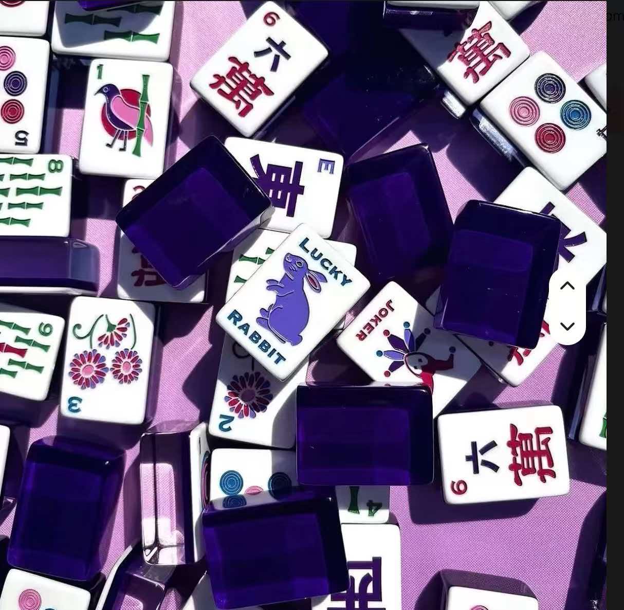 Purple-backed mahjong set on a blue playing surface